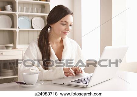Stock Photo - Young woman using laptop. Fotosearch