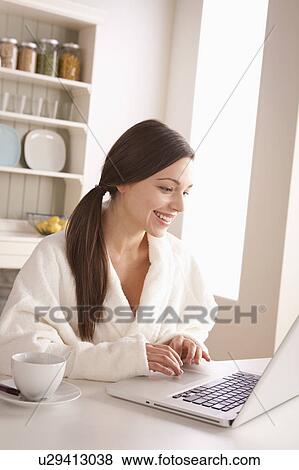 Young woman using laptop View Large Photo Image Stock Photo - Young woman using laptop. Fotosearch