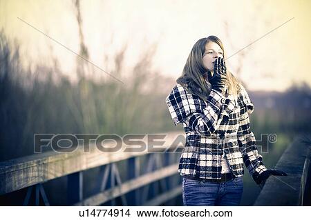 Young woman walking in winter sun View Large Photo Image Picture - Young woman walking in winter sun. Fotosearch