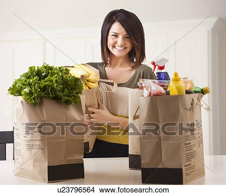 Young woman with paper bags after shopping View Large Photo Image Picture - Young woman with paper bags after shopping. Fotosearch
