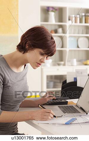 Young woman working at home View Large Photo Image Stock Photography - Young woman working at home. Fotosearch