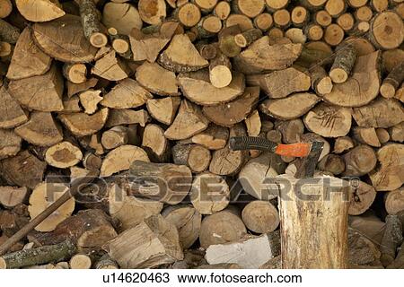 Stock Image - Axe stuck in chopping block. Fotosearch
