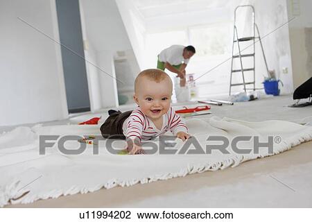 Baby crawling on rug in new home View Large Photo Image Stock Image - Baby crawling on rug in new home. Fotosearch
