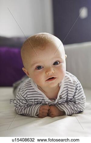 Baby laying on sofa View Large Photo Image Stock Image - Baby laying on sofa. Fotosearch