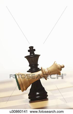 Black chess king holding white queen View Large Photo Image Stock Image - Black chess king holding white queen. Fotosearch