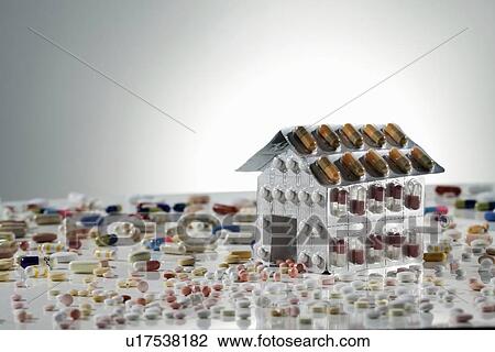 Stock Image - Blister packs of pills in shape of house. Fotosearch