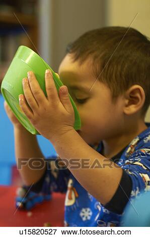 Stock Photo - Boy drinking cereal milk. Fotosearch