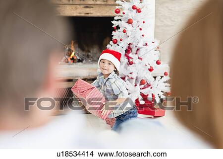 Boy in Santa hat with Christmas gifts View Large Photo Image Picture - Boy in Santa hat with Christmas gifts. Fotosearch