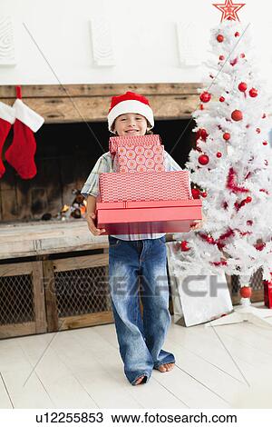 Boy in Santa hat with Christmas gifts View Large Photo Image Stock Image - Boy in Santa hat with Christmas gifts. Fotosearch