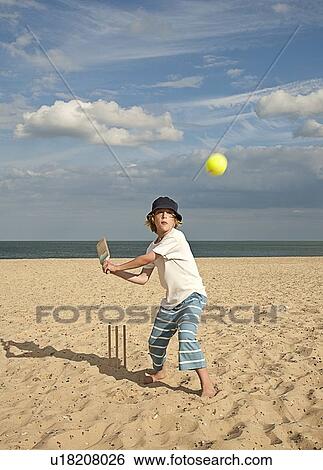 Boy playing cricket on beach View Large Photo Image Stock Photograph - Boy playing cricket on beach. Fotosearch