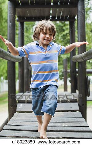 Boy playing on play structure View Large Photo Image Stock Photo - Boy playing on play structure. Fotosearch