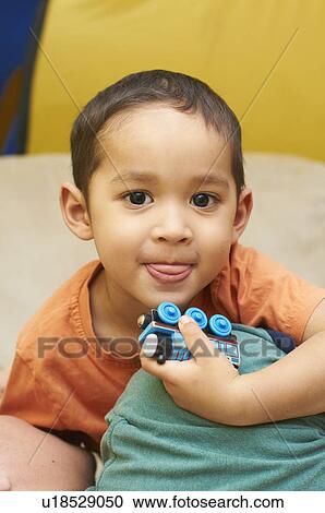 Boy playing with toy train View Large Photo Image Stock Image - Boy playing with toy train. Fotosearch