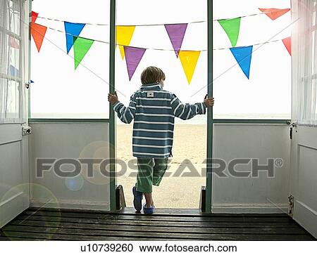 Boy standing in doorway of hut View Large Photo Image Stock Image - Boy standing in doorway of hut. Fotosearch
