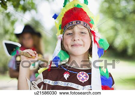 Stock Image - Boy wearing Indian costume outdoors. Fotosearch