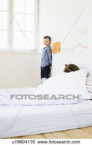 Boy with drawings on bedroom wall View Large Photo Image Stock Photograph - Boy with drawings on bedroom wall. Fotosearch