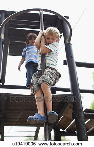 Boys playing on play structure together View Large Photo Image Stock Photograph - Boys playing on play structure together. Fotosearch