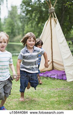Boys playing together outdoors View Large Photo Image Picture - Boys playing together outdoors. Fotosearch