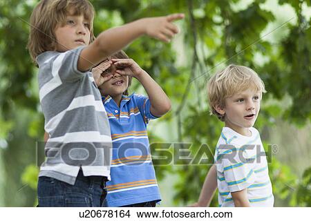Boys playing together outdoors View Large Photo Image Picture - Boys playing together outdoors. Fotosearch