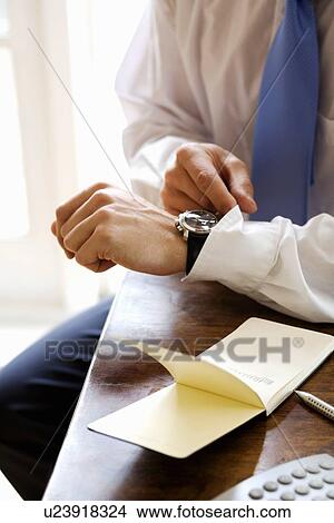 Picture - Businessman checking his watch. Fotosearch