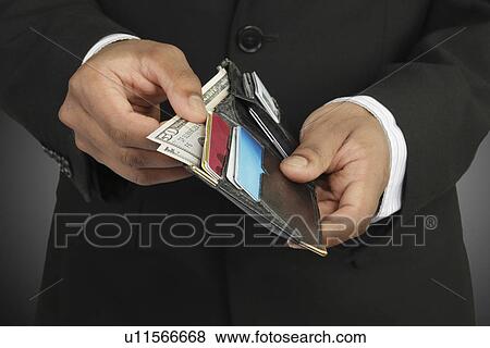 Businessman counting money in wallet View Large Photo Image Stock Photo - Businessman counting money in wallet. Fotosearch