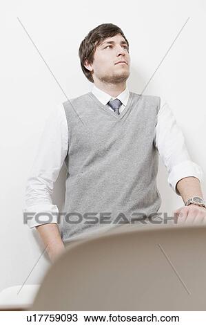 Businessman leaning against wall View Large Photo Image Stock Image - Businessman leaning against wall. Fotosearch