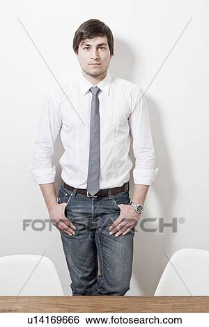 Stock Photograph - Businessman leaning against wall. Fotosearch
