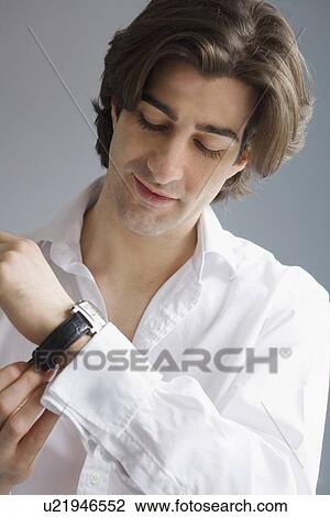 Businessman putting on watch View Large Photo Image Stock Image - Businessman putting on watch. Fotosearch