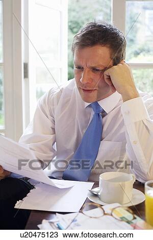 Businessman reading at breakfast View Large Photo Image Stock Image - Businessman reading at breakfast. Fotosearch