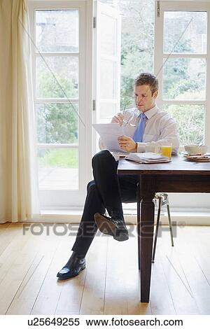 Businessman reading at breakfast View Large Photo Image Stock Photography - Businessman reading at breakfast. Fotosearch