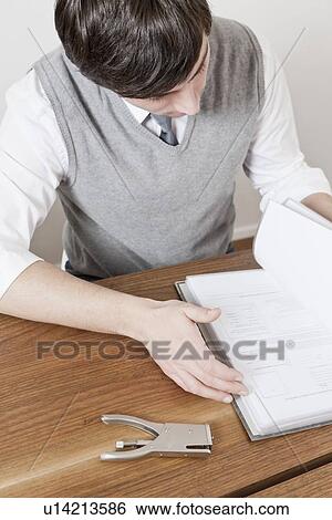 Businessman reading book at desk View Large Photo Image Stock Photograph - Businessman reading book at desk. Fotosearch