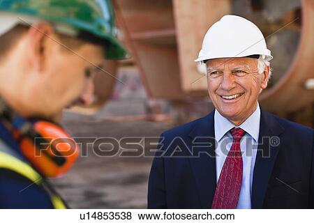 Businessman smiling on dry dock View Large Photo Image Stock Photo - Businessman smiling on dry dock. Fotosearch