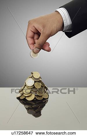 Businessman stacking Euro coins View Large Photo Image Stock Photo - Businessman stacking Euro coins. Fotosearch