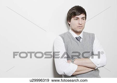 Stock Photo - Businessman standing with arms crossed. Fotosearch