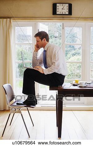 Businessman using laptop at breakfast View Large Photo Image Picture - Businessman using laptop at breakfast. Fotosearch