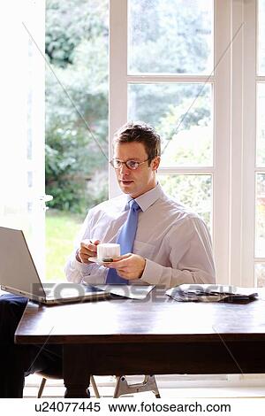 Businessman using laptop at breakfast View Large Photo Image Stock Photography - Businessman using laptop at breakfast. Fotosearch