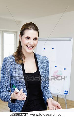 Businesswoman laughing in office View Large Photo Image Stock Photo - Businesswoman laughing in office. Fotosearch