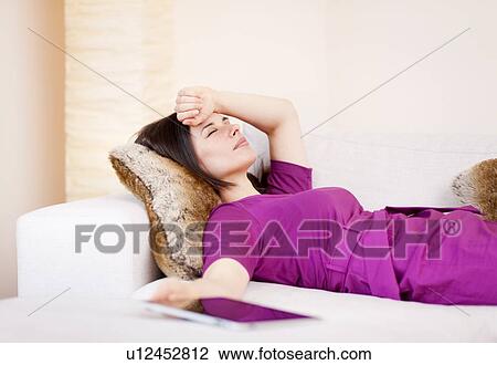 Businesswoman relaxing on sofa View Large Photo Image Stock Image - Businesswoman relaxing on sofa. Fotosearch