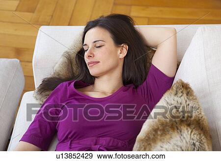 Businesswoman relaxing on sofa View Large Photo Image Stock Photo - Businesswoman relaxing on sofa. Fotosearch