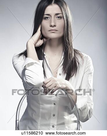Businesswoman sitting in plastic chair View Large Photo Image Stock Image - Businesswoman sitting in plastic chair. Fotosearch