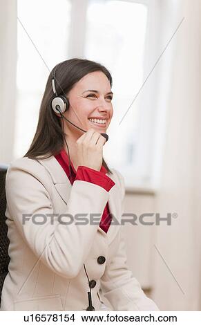 Businesswoman talking on headset View Large Photo Image Picture - Businesswoman talking on headset. Fotosearch
