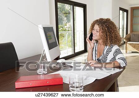 Businesswoman using computer at desk View Large Photo Image Stock Photo - Businesswoman using computer at desk. Fotosearch