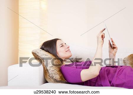 Businesswoman using tablet computer View Large Photo Image Stock Image - Businesswoman using tablet computer. Fotosearch