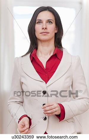 Businesswoman walking in office View Large Photo Image Stock Photo - Businesswoman walking in office. Fotosearch