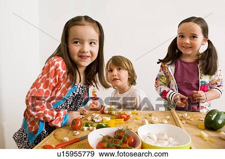 Children cooking together in kitchen View Large Photo Image Stock Photo - Children cooking together in kitchen. Fotosearch