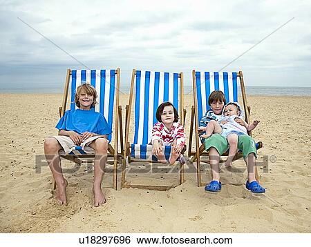 Children in lawn chairs on beach View Large Photo Image Stock Photograph - Children in lawn chairs on beach. Fotosearch