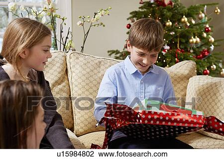 Children opening Christmas gifts View Large Photo Image Stock Image - Children opening Christmas gifts. Fotosearch