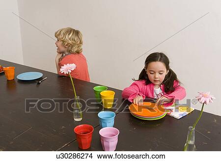 Children playing at table in kitchen View Large Photo Image Picture - Children playing at table in kitchen. Fotosearch