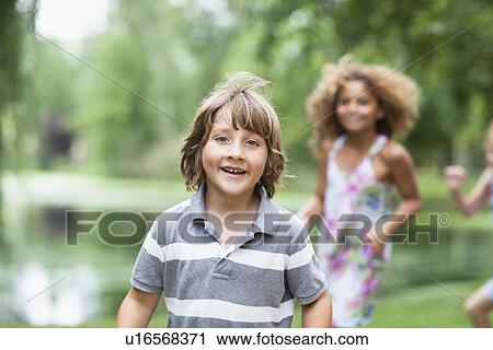 Stock Image - Children playing together outdoors. Fotosearch