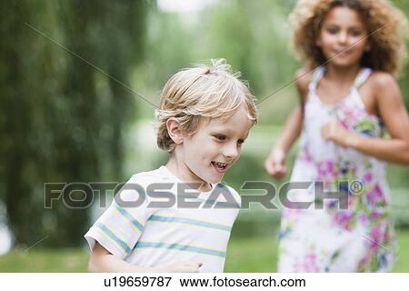 Children playing together outdoors View Large Photo Image Stock Photo - Children playing together outdoors. Fotosearch