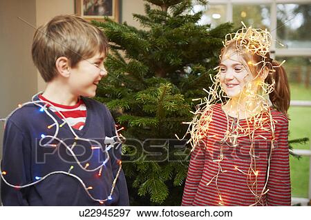 Children playing with Christmas lights View Large Photo Image Stock Photo - Children playing with Christmas lights. Fotosearch